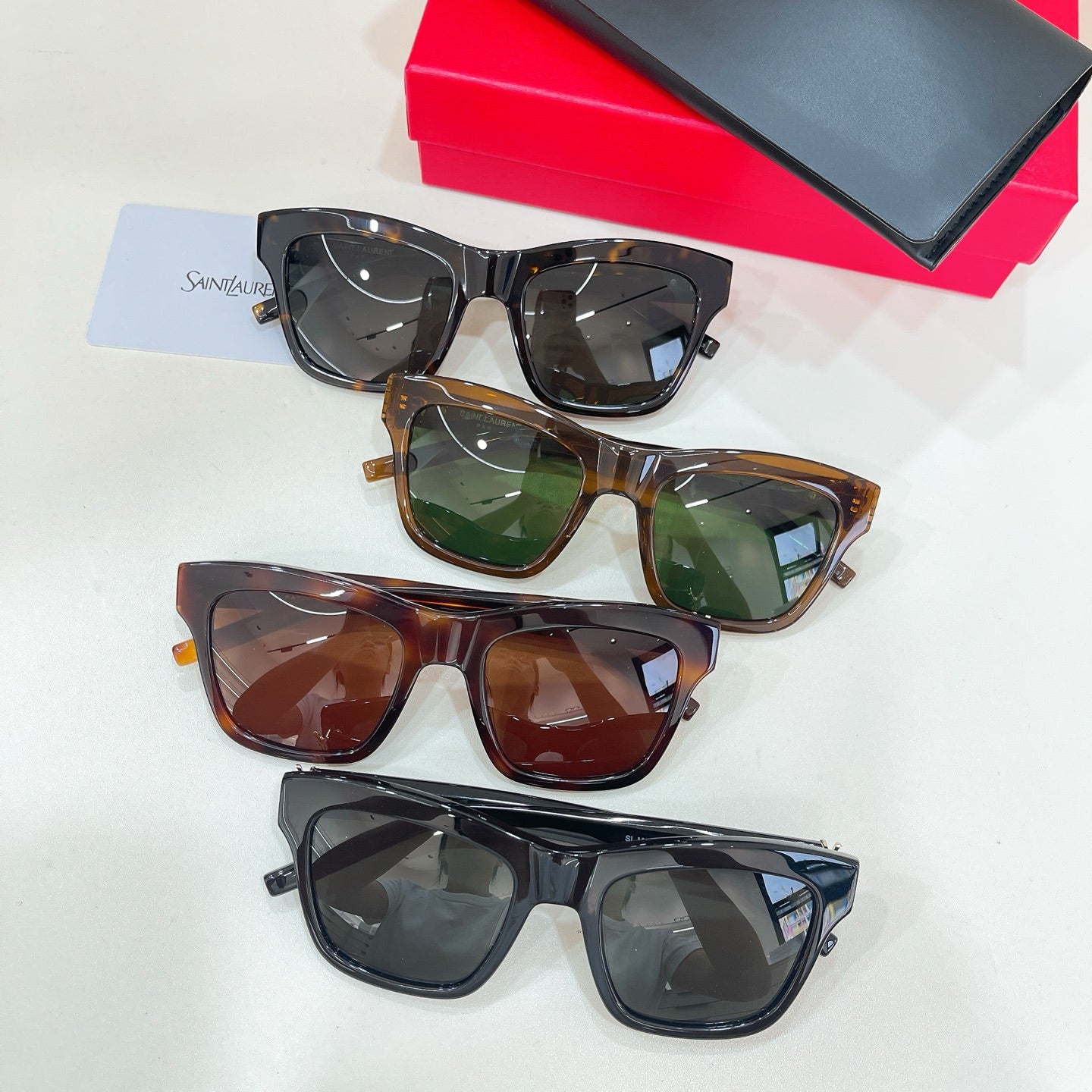 YSL sunglasses set showing four pairs in black, tortoise, and dark lenses