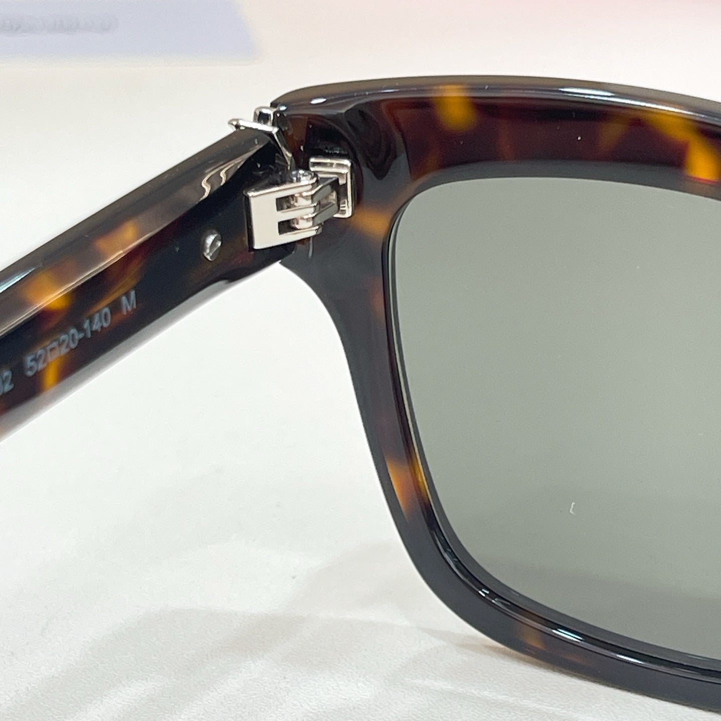 YSL sunglasses temple and hinge detail, tortoise frame with dark lenses