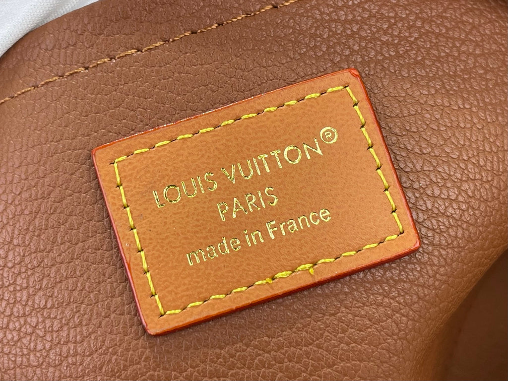 Louis Vuitton bag leather patch with neon yellow stitching, “Made in France” text
