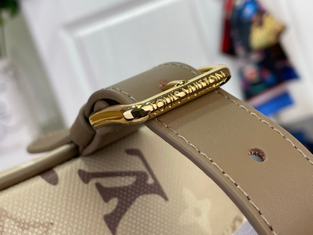 Louis Vuitton bag strap and gold zipper pull on beige monogram canvas