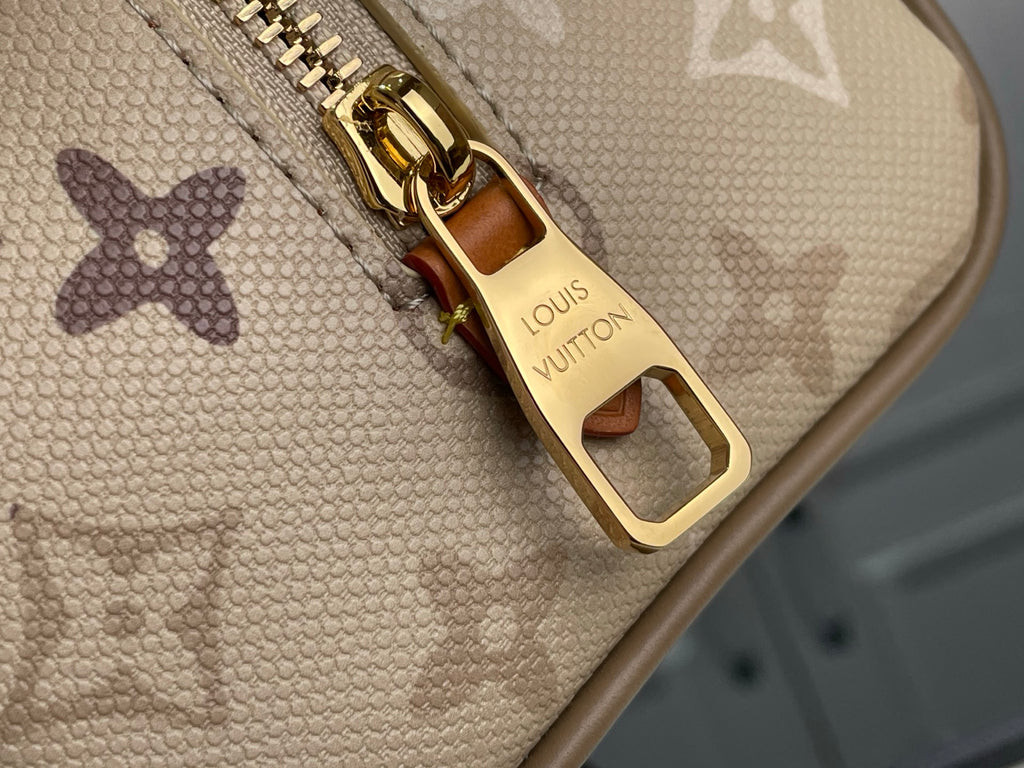 Louis Vuitton zipper pull with gold hardware on beige monogram canvas