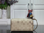 Louis Vuitton bag with beige monogram exterior, rounded handle, and side attachment loop
