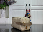 Louis Vuitton bag in beige monogram canvas, side view with adjustable leather strap and buckle