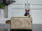 Louis Vuitton bag in beige with monogram pattern, rounded top and front zipper detail