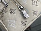 Silver zipper pull on cream monogram bag with blue bow pattern