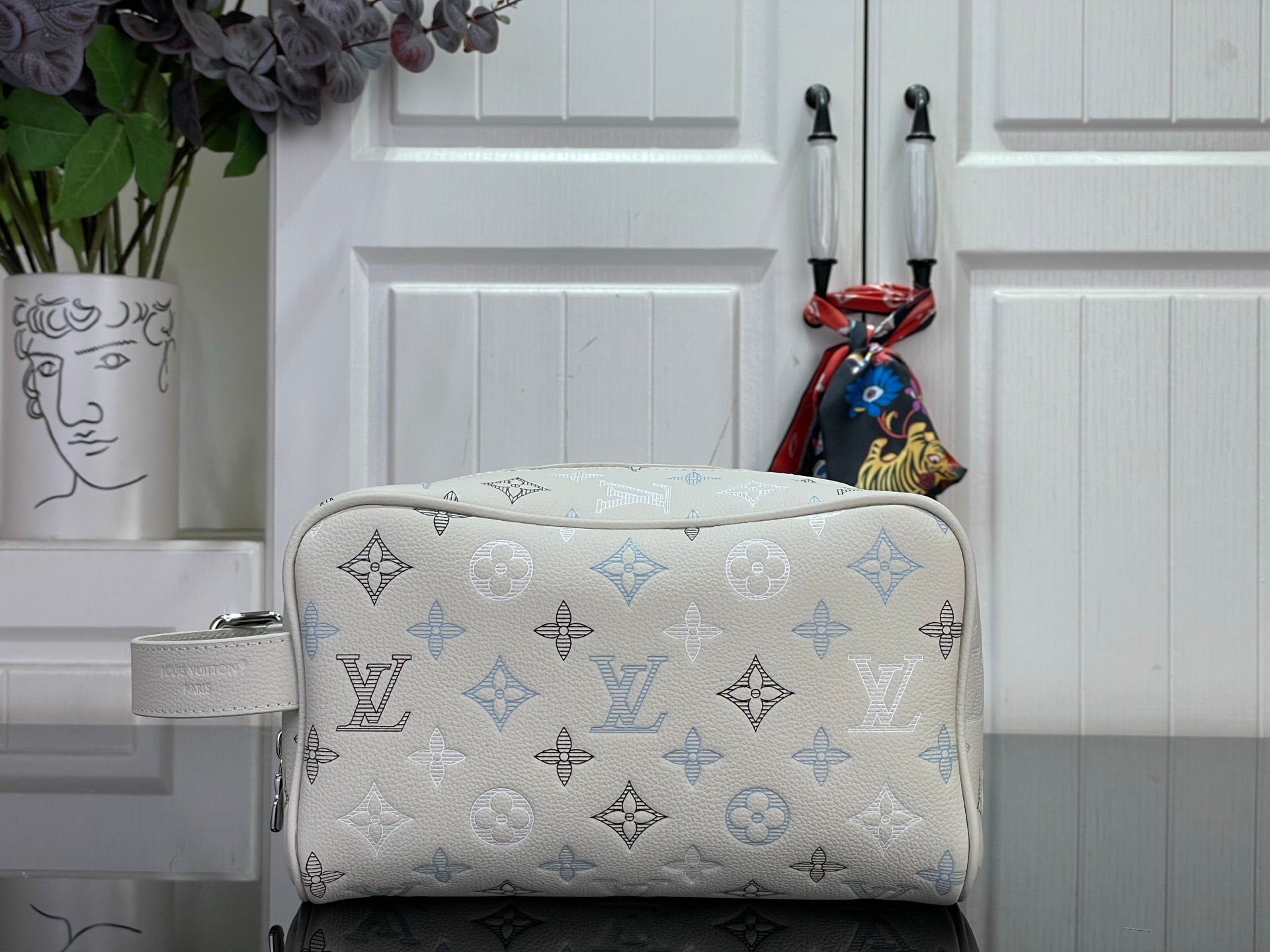 Cream monogram top-zip handbag with blue pattern and silver-tone hardware