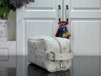 Cream monogram shoulder bag with blue icons, front strap, and silver buckle