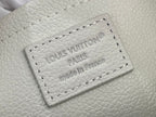 Stamped Louis Vuitton Paris logo patch on cream leather with stitched border