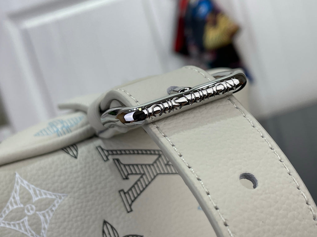 Cream leather bag zipper pull with silver ring and monogram-printed panel