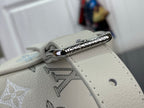 Cream leather bag zipper pull with silver ring and monogram-printed panel