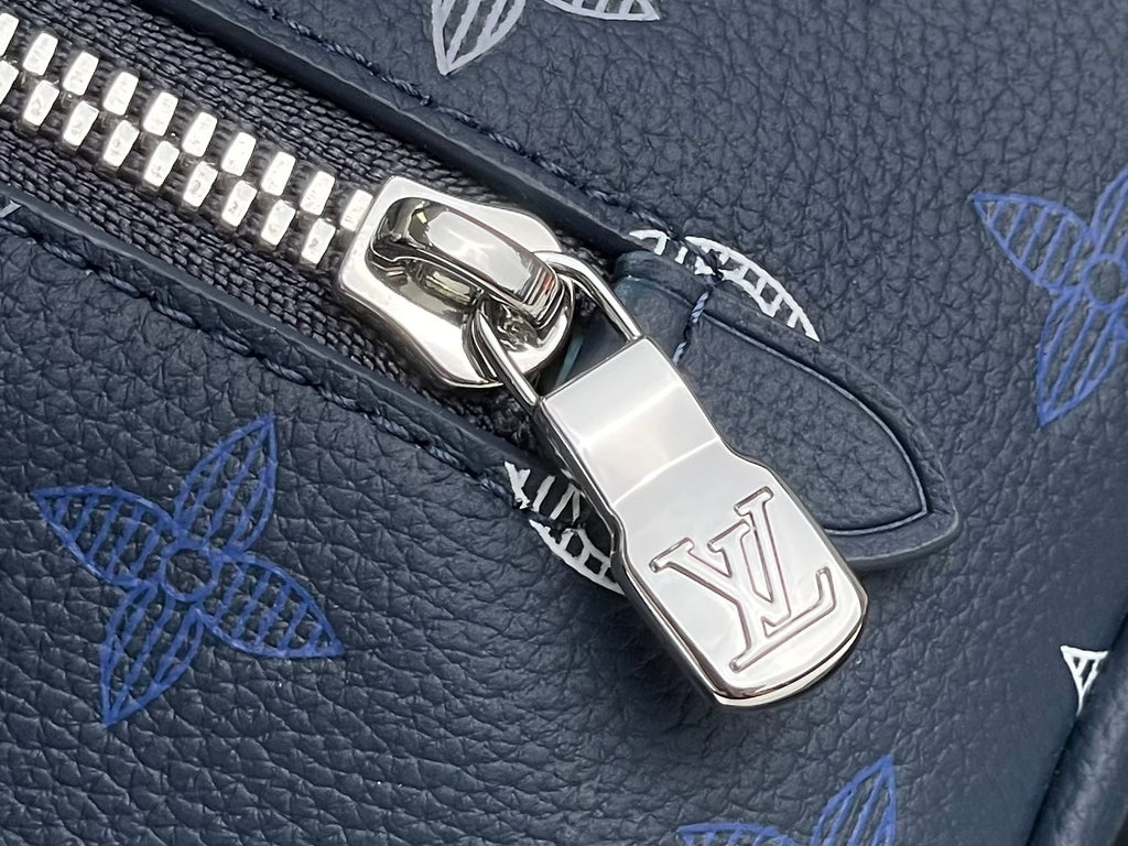 Louis Vuitton bag close-up of silver zipper pull over blue monogram pattern