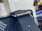 Louis Vuitton bag close-up of navy strap and silver zipper pull hardware