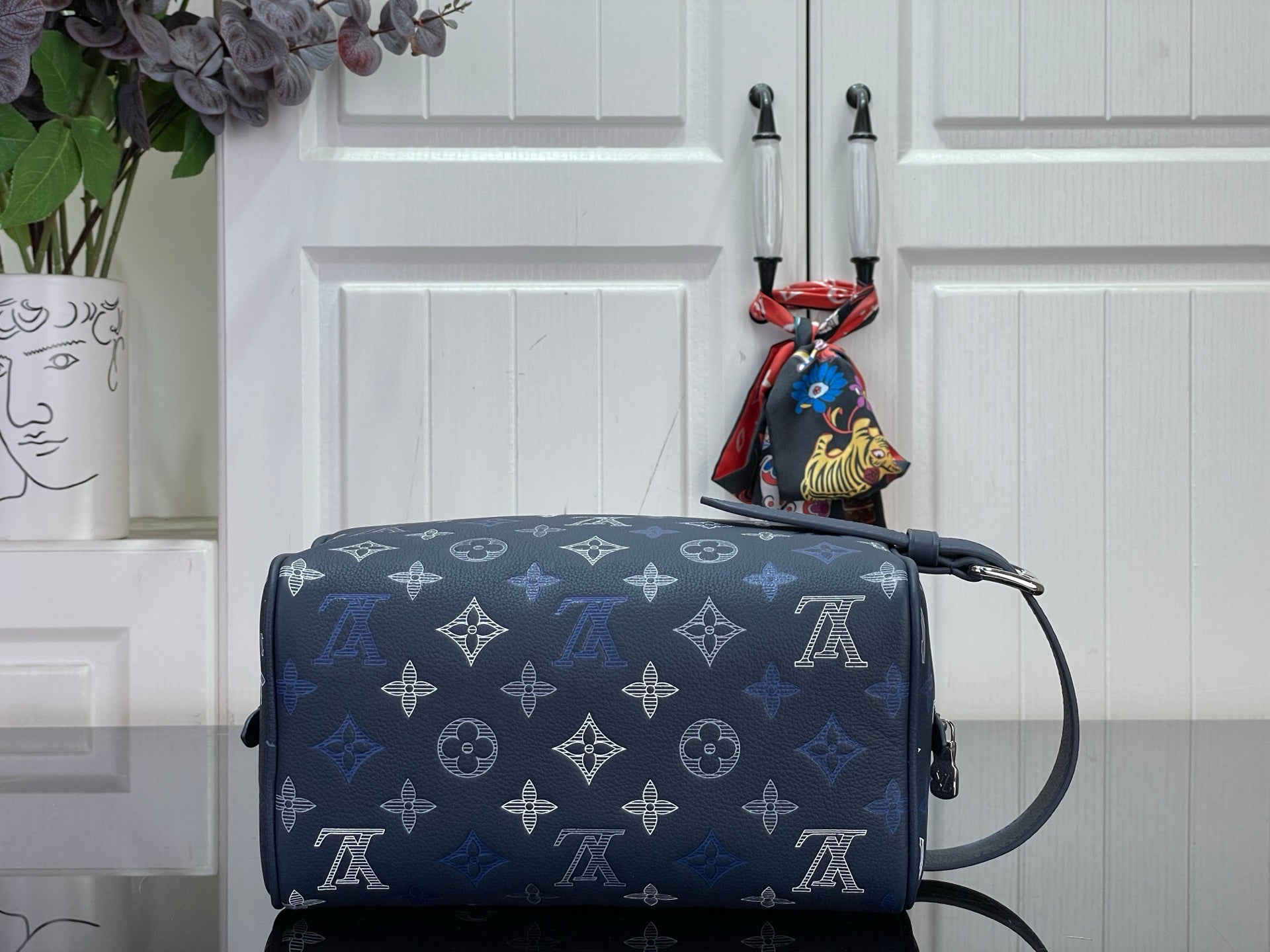 Louis Vuitton bag in dark navy with monogram and top zipper with adjustable strap