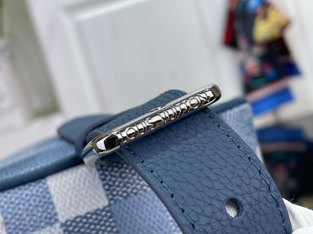 Brushed metal zipper pull on textured blue bag