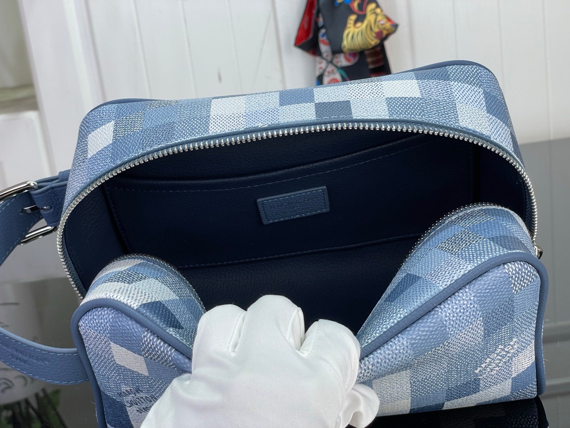 Blue check bag interior with dark lining and zip closure