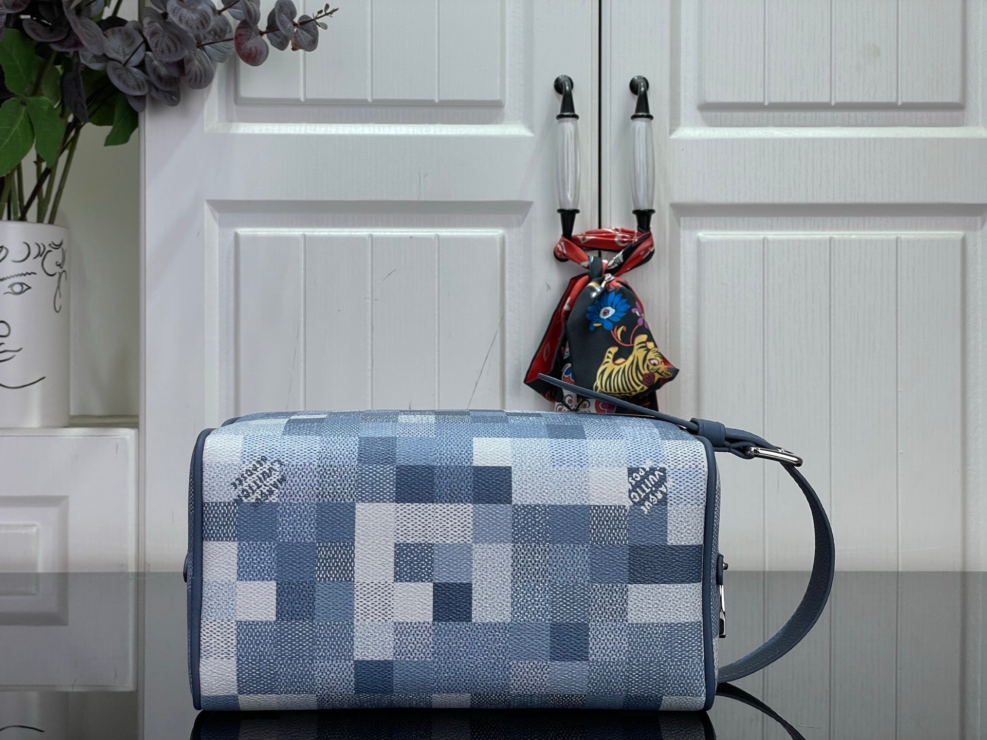 Blue check handbag with long strap and top zipper