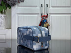 Blue check shoulder bag with zipped top and side strap buckle