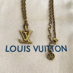 Gold-tone Louis Vuitton necklace with LV logo pendant and round charm