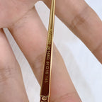 Gold temple arm close-up with engraved numbers and BVLGARI text