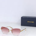 Bvlgari sunglasses with gold metal frame and pink tinted lenses, front angle.