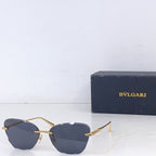 Bvlgari sunglasses with gold metal frame and dark gray lenses, front angle.