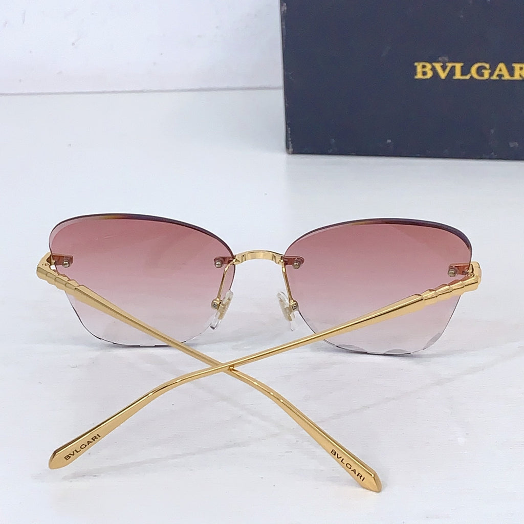 Bvlgari sunglasses with pink tinted lenses and gold frame, crossed temples.