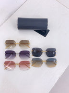 Bvlgari sunglasses set with mixed lens colors: dark blue, pink, and beige on table