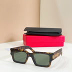 YSL glasses, tortoiseshell square frame with green-tinted lenses and gold side logo