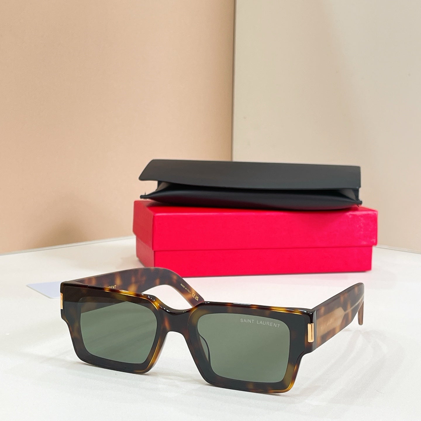 YSL glasses, tortoiseshell square frame with green-tinted lenses and gold side logo