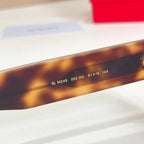 YSL glasses temple closeup with model numbers and gold lettering on tortoiseshell