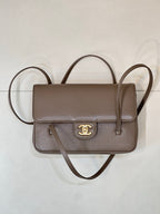 Taupe Chanel small shoulder bag with flap front, gold CC emblem, and two straps