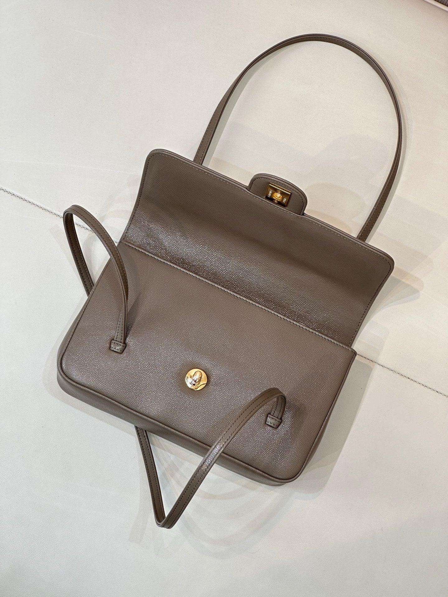 Taupe Chanel tote-style bag with short top handle, front clasp, and gold hardware