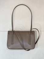 Taupe Chanel cross-body bag with top handles, front flap, and side strap loops