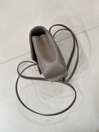Taupe Chanel small leather bag with side pocket, gold hardware, and long strap