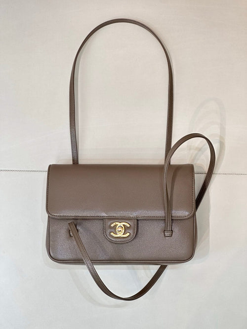 Taupe Chanel shoulder bag with top handle, flap front, and gold CC clasp