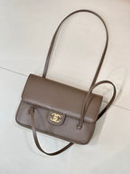 Taupe Chanel shoulder bag with cross-body strap, front flap, and gold CC logo