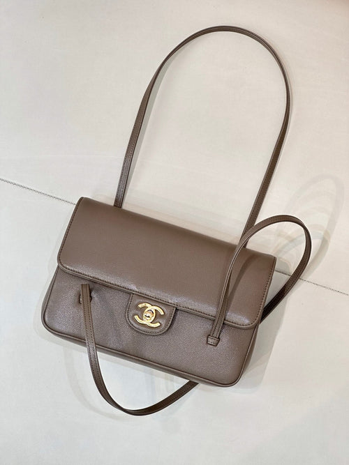 Taupe Chanel shoulder bag with cross-body strap, front flap, and gold CC logo