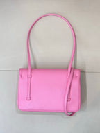 Pink structured handbag with top handles, front closure, and crossbody strap