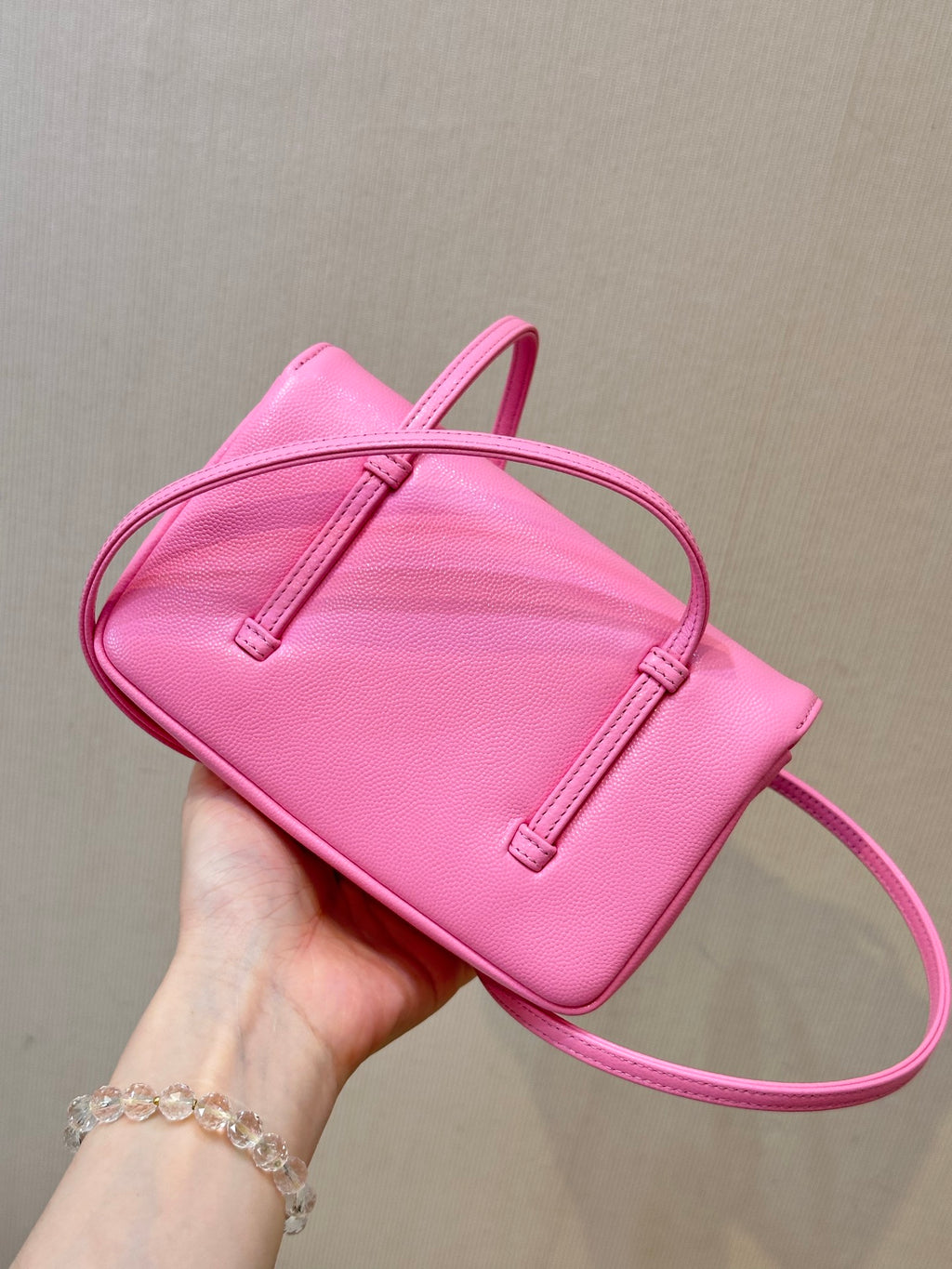Chanel pink mini shoulder bag with flap top, double handle straps, and stitched tabs