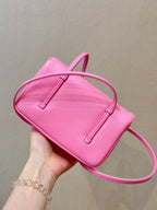 Chanel pink mini shoulder bag with flap top, double handle straps, and stitched tabs