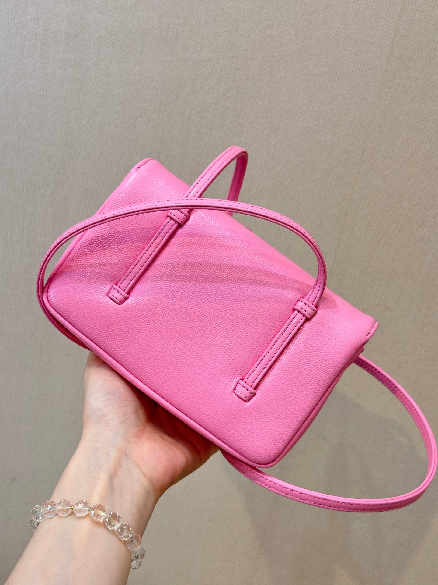 Chanel pink mini shoulder bag with flap top, double handle straps, and stitched tabs