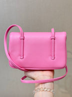 Chanel pink mini crossbody bag with flap, two side straps, and top handle loop