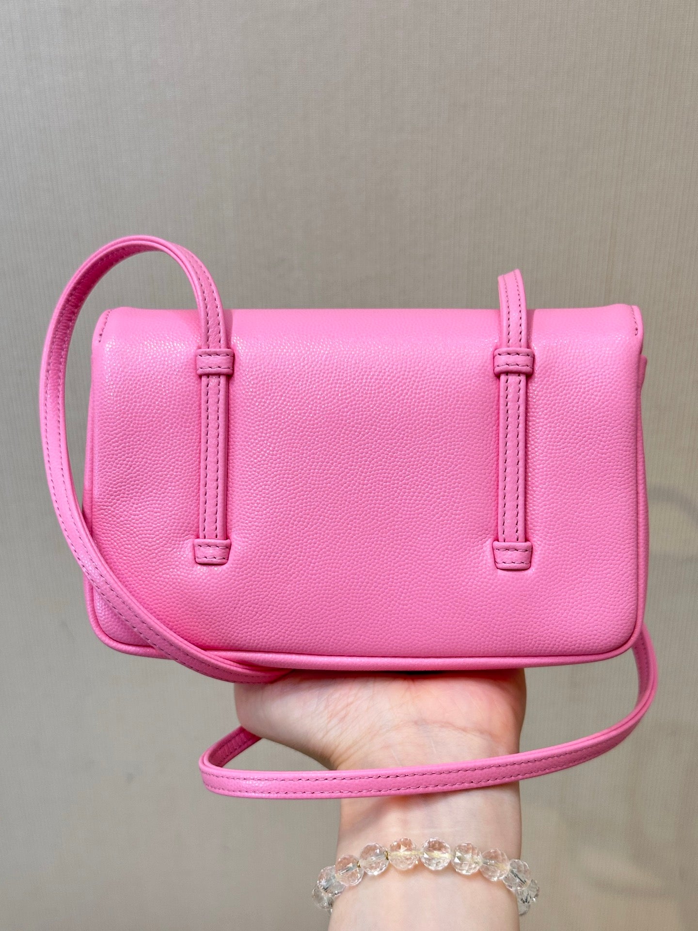 Chanel pink mini crossbody bag with flap, two side straps, and top handle loop