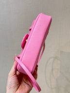 Chanel pink mini bag side view with flap closure and adjustable crossbody strap