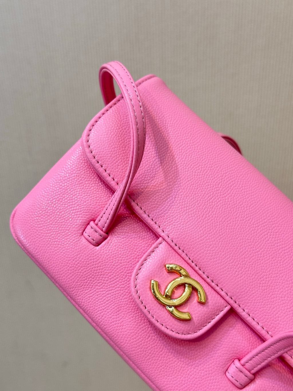 Chanel pink mini bag corner detail with front flap and gold CC logo clasp