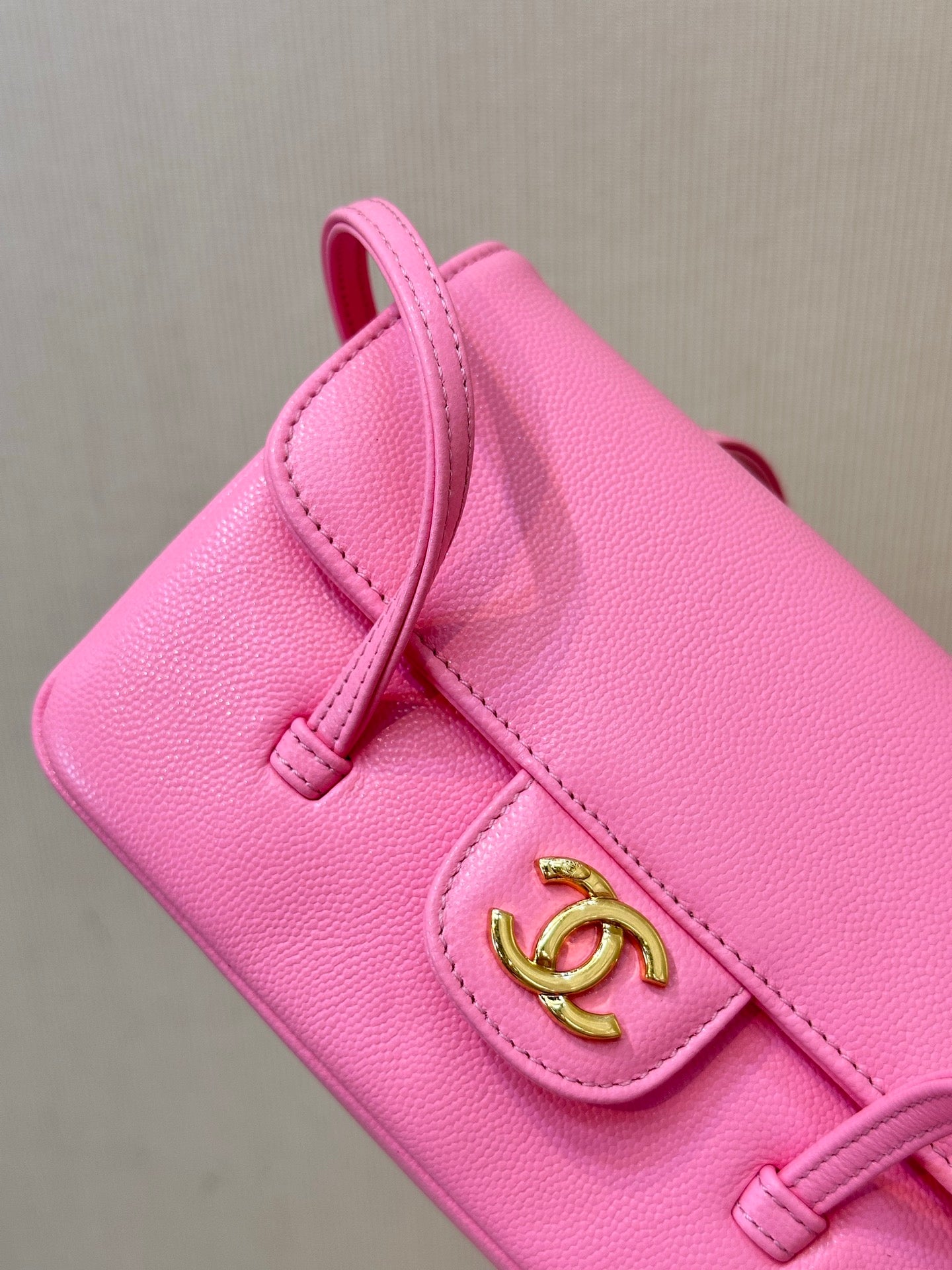 Chanel pink mini bag corner detail with front flap and gold CC logo clasp