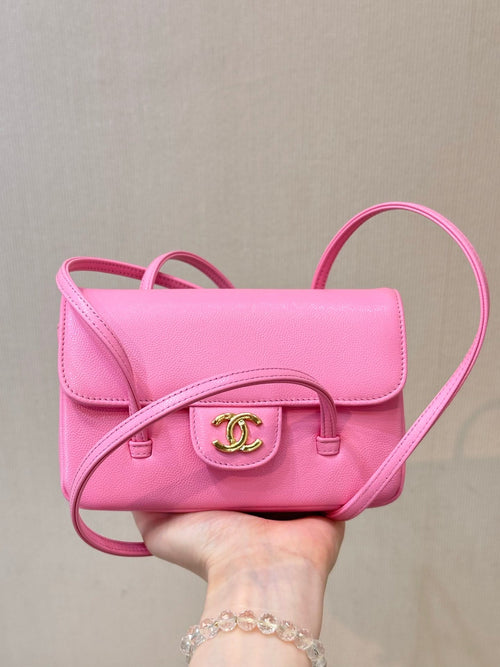 Chanel pink mini shoulder bag with front flap and gold CC emblem, crossbody strap