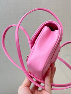 Chanel pink mini bag showing interior opening and smooth lining, crossbody strap