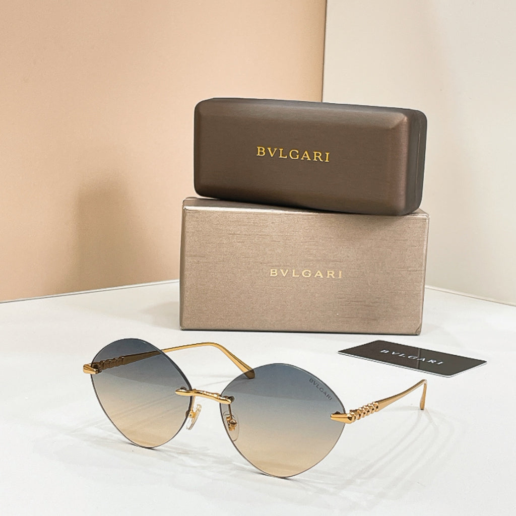 Sunglasses with gold-tone frame and dark round lenses