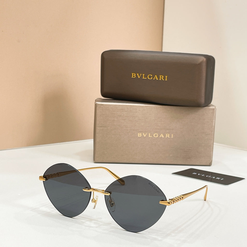 Sunglasses with gold-tone frame and dark round tinted lenses